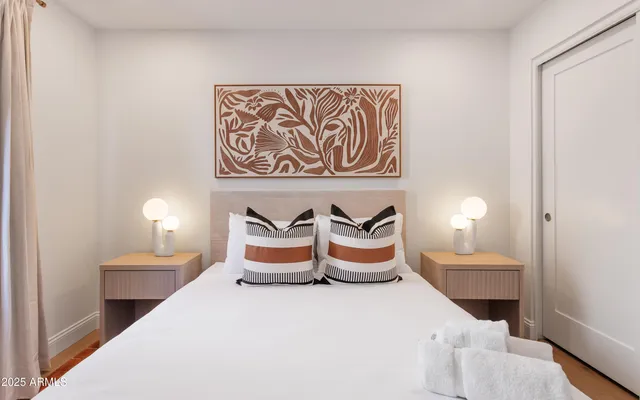 a bedroom with furniture and a lamp