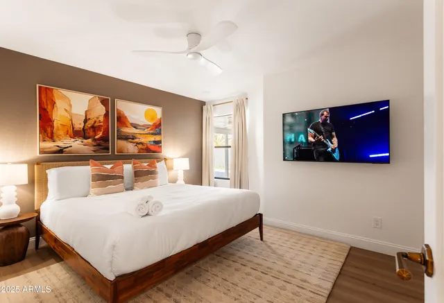 a bedroom with a bed and wooden floor