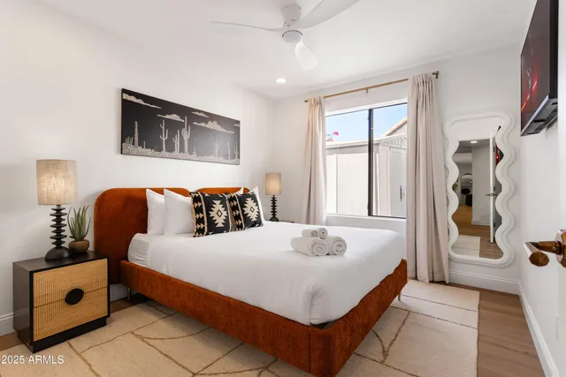 a bedroom with a bed and a window