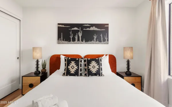 a bed room with large bed and wooden floor