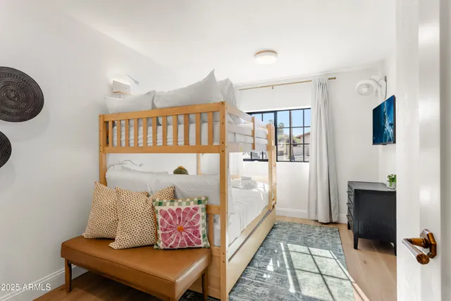 a bedroom with furniture and a window