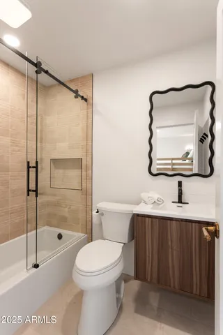 a bathroom with a toilet a sink and a mirror