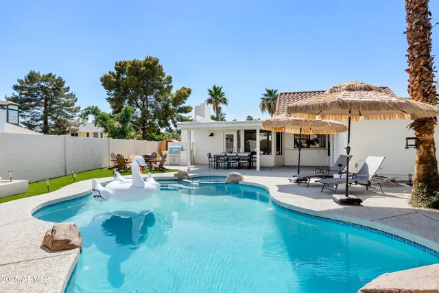 a view of a swimming pool with lounge chairs