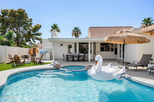 a view of a house with backyard and sitting area