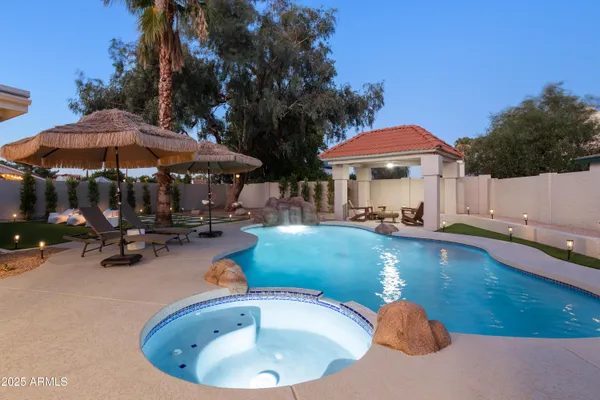 a view of a house with swimming pool and sitting area