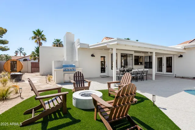 a view of a patio with table and chairs potted plants and a palm tree