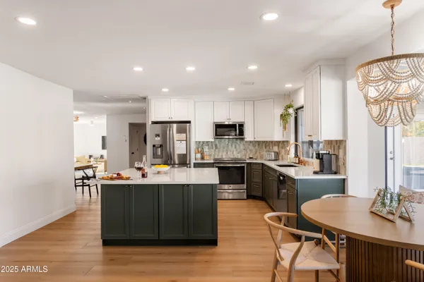 a living room with stainless steel appliances kitchen island granite countertop furniture a kitchen a sink a stove and kitchen island