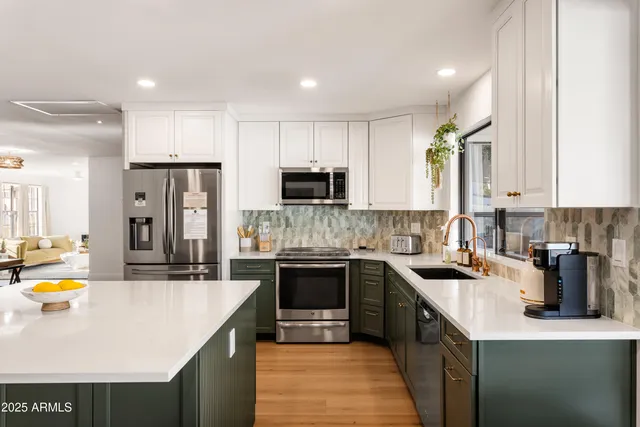 a kitchen with stainless steel appliances granite countertop a sink stove and refrigerator