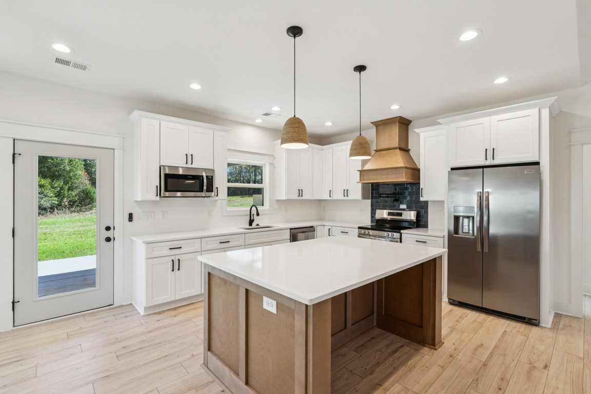 3666 Clark Road Lewisburg, TN 37091 - Photo 6 of 21 a kitchen with white cabinets and stainless steel appliances