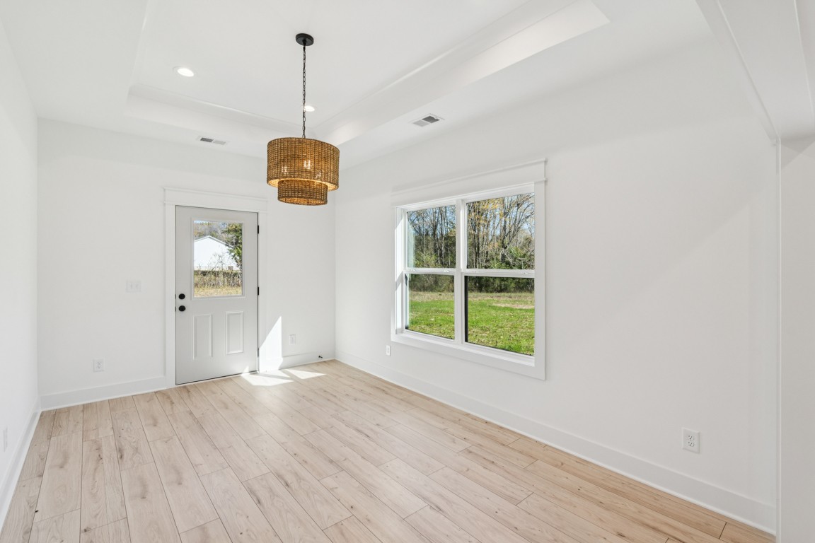 3666 Clark Road Lewisburg, TN 37091 - Photo 7 of 21 a view of an empty room with wooden floor and windows