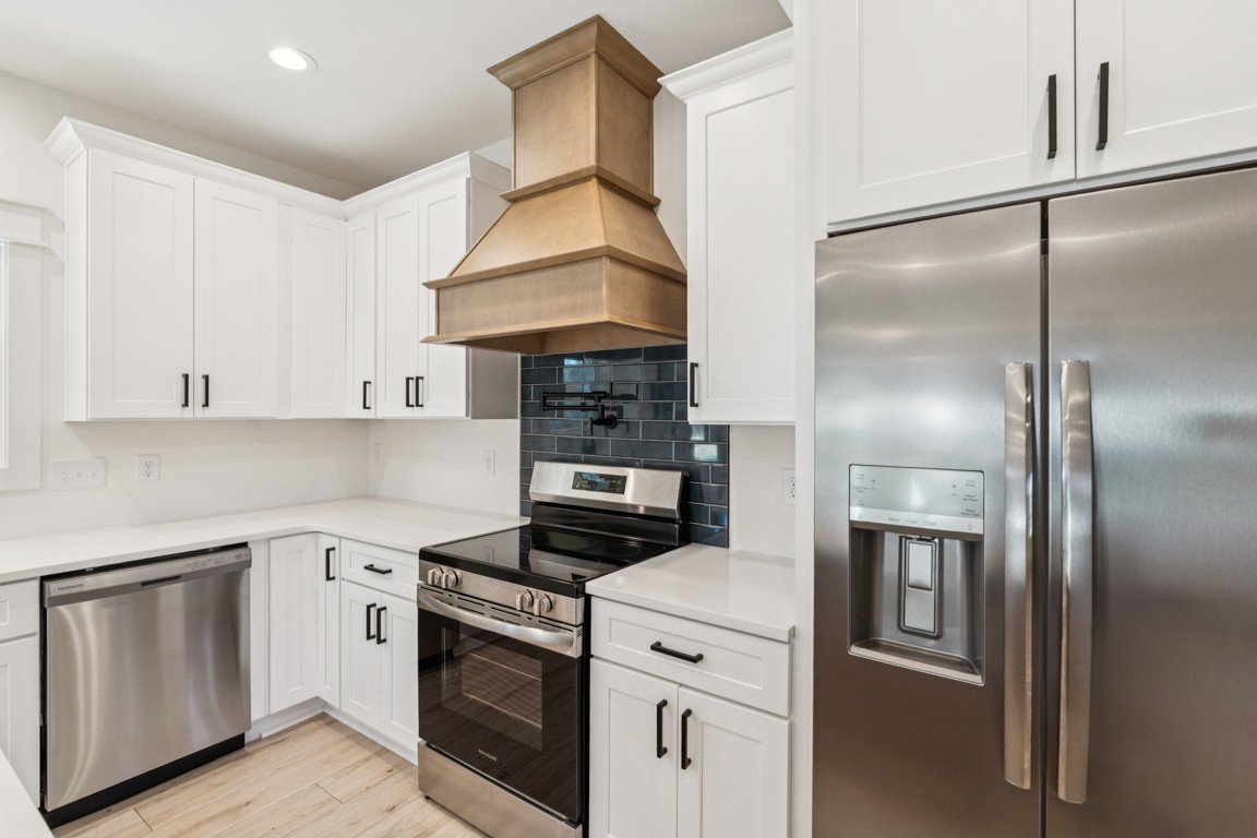 3666 Clark Road Lewisburg, TN 37091 - Photo 8 of 21 a kitchen with stainless steel appliances granite countertop a refrigerator a stove and white cabinets