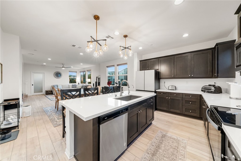 329 North Standard Avenue Santa Ana, CA 92701 - Photo 11 of 34 a large kitchen with kitchen island a sink counter space and stainless steel appliances