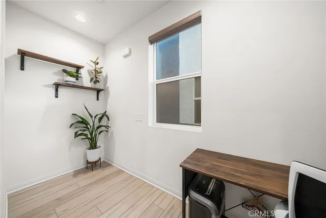 a view of a workspace with furniture and wooden floor