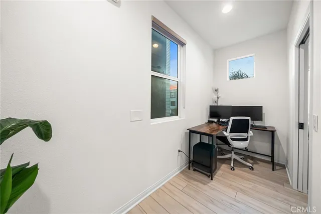 a view of a room with a potted plant and wooden floor