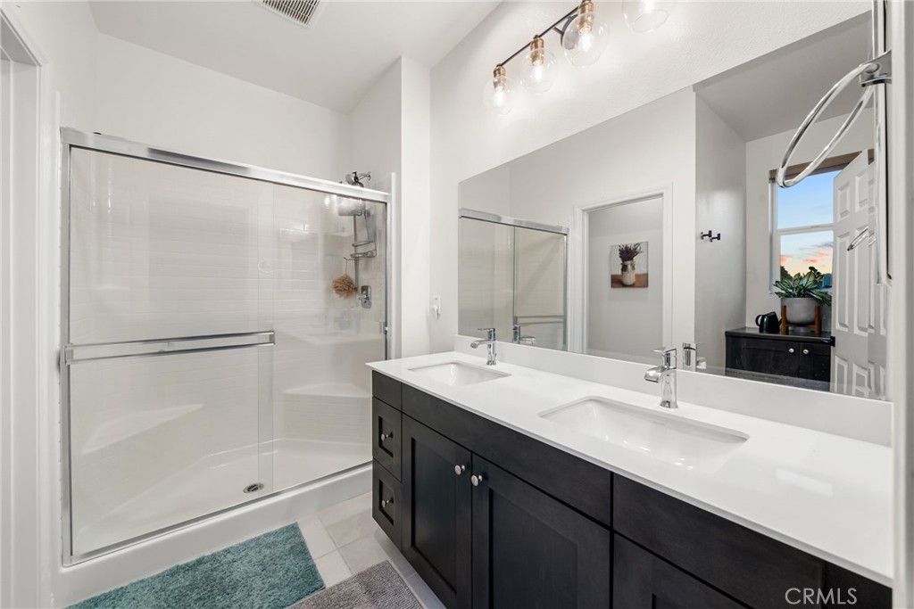 329 North Standard Avenue Santa Ana, CA 92701 - Photo 24 of 34 a bathroom with a double vanity sink mirror and shower