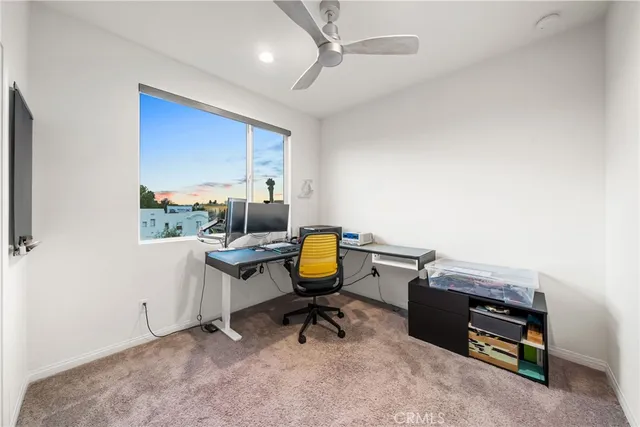 a bedroom with a bed a table and painting on the wall