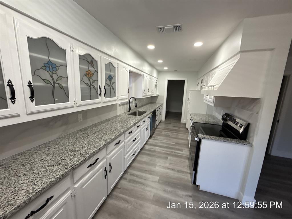 2847 West Rochelle Road Irving, TX 75062 - Photo 2 of 11 a large kitchen with stainless steel appliances granite countertop a lot of counter space and a sink