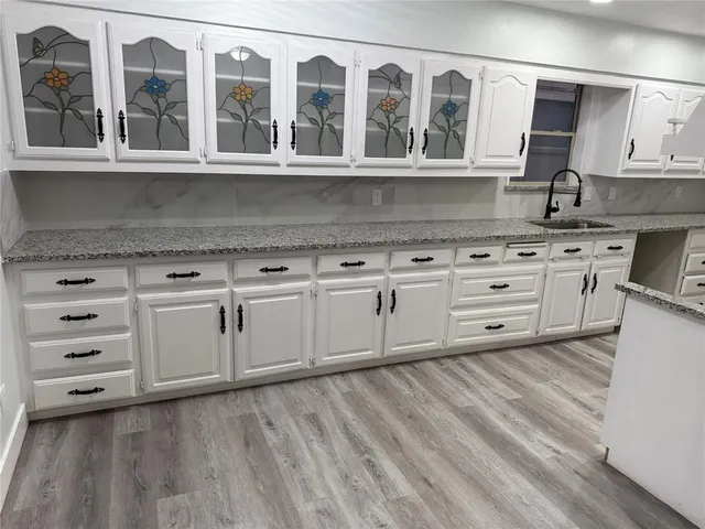 a kitchen with stainless steel appliances granite countertop a stove a sink and a granite counter tops