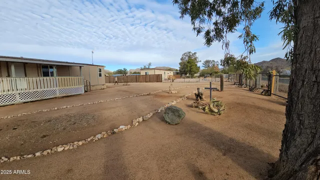 a view of a backyard with table and chairs and a fire pit