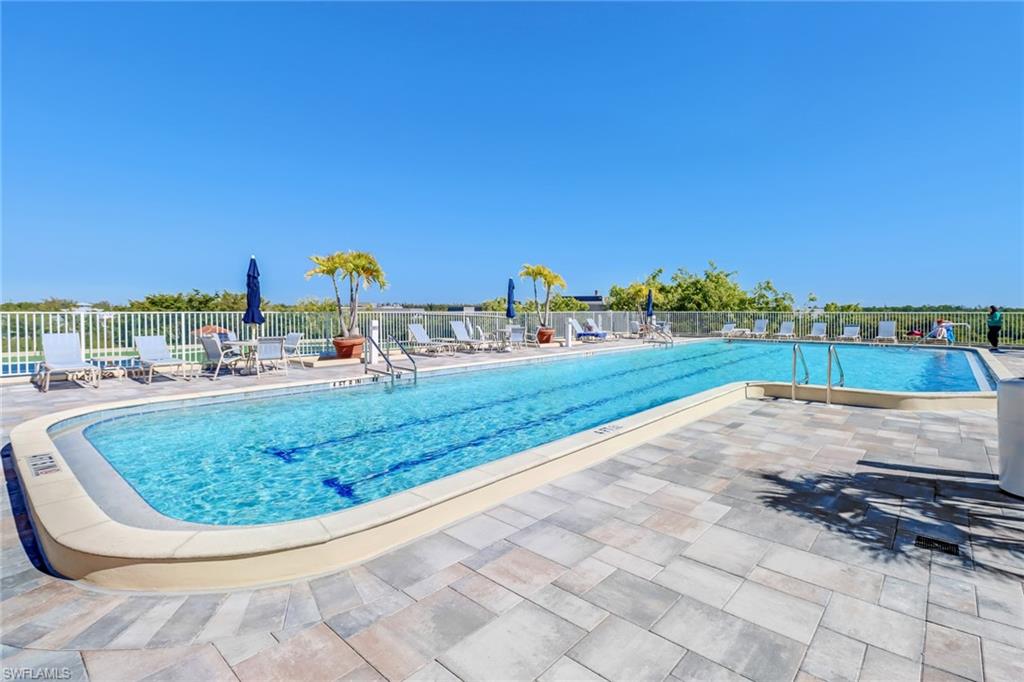 451 Bayfront Place, Unit 5505 Naples, FL 34102 - Photo 17 of 23 a view of a swimming pool with a lawn chairs