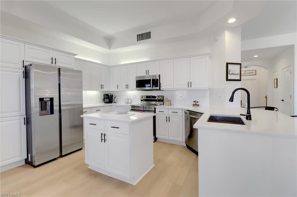451 Bayfront Place, Unit 5505 Naples, FL 34102 - Photo 3 of 23 a kitchen with stainless steel appliances a refrigerator stove microwave and sink