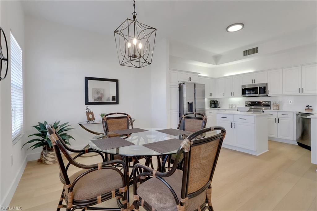 451 Bayfront Place, Unit 5505 Naples, FL 34102 - Photo 4 of 23 a view of a dining room with furniture and a chandelier