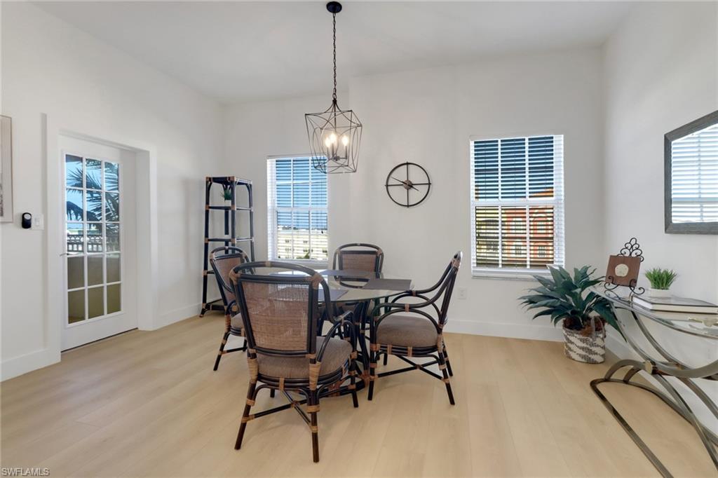 451 Bayfront Place, Unit 5505 Naples, FL 34102 - Photo 5 of 23 a view of a dining room with furniture window and wooden floor