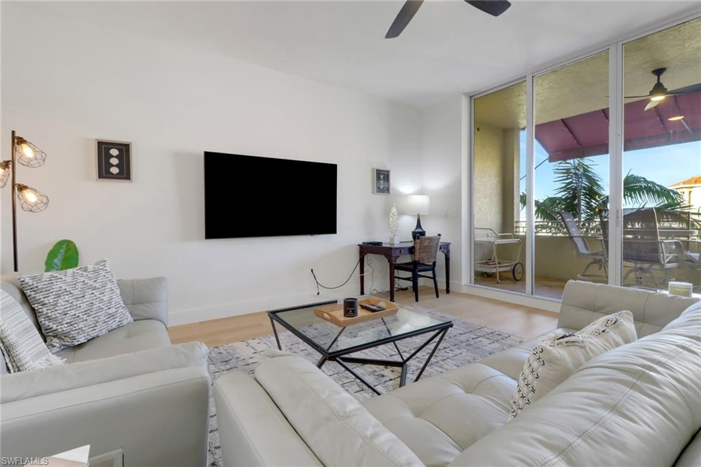 451 Bayfront Place, Unit 5505 Naples, FL 34102 - Photo 7 of 23 a living room with furniture and a flat screen tv