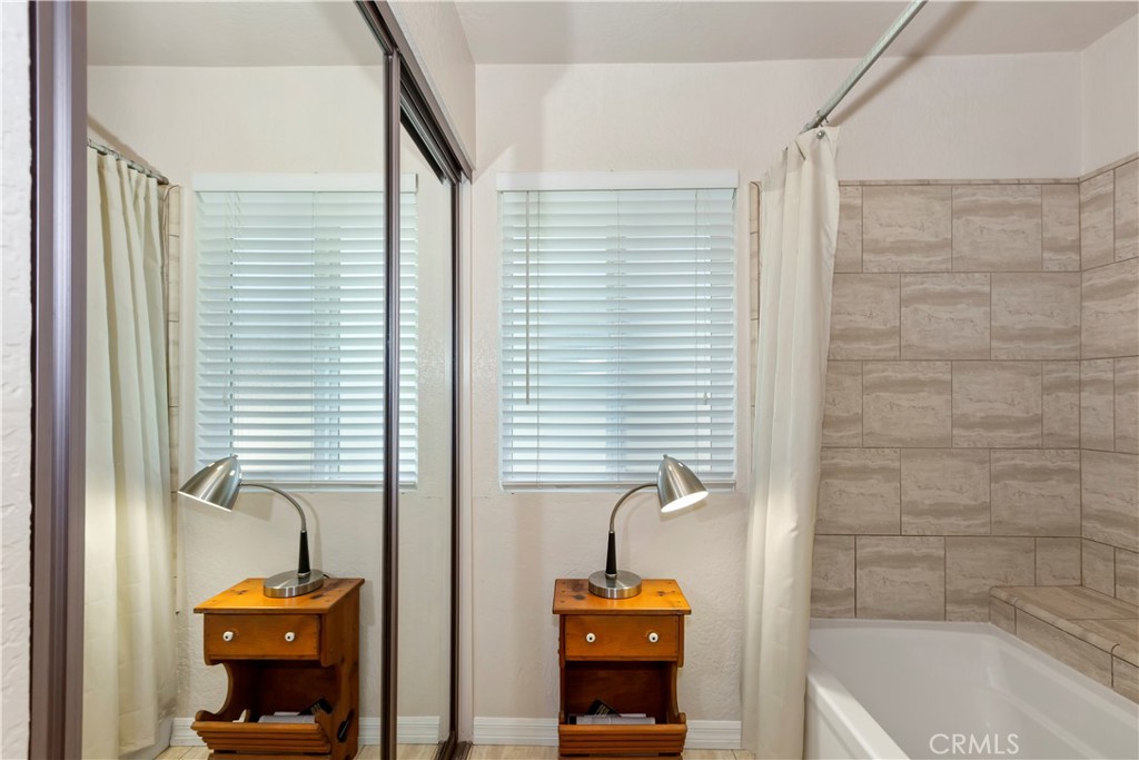 8527 Hillside Road Rancho Cucamonga, CA 91701 - Photo 29 of 50 a bathroom with a window a sink and a bathtub