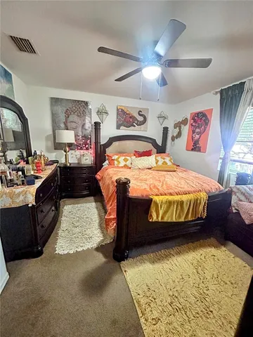 a bedroom with bed and window