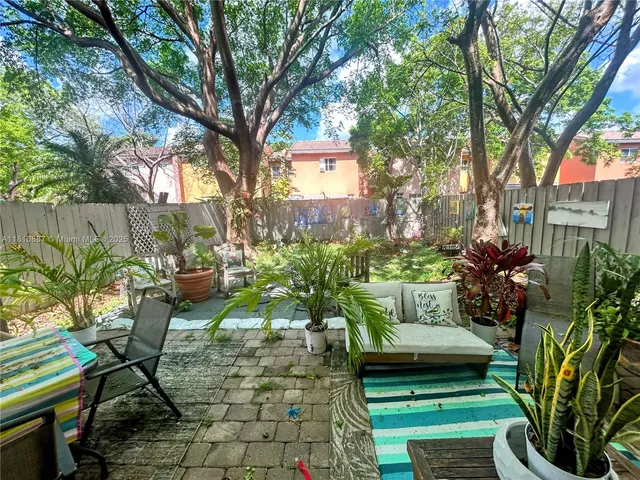 a view of a yard with furniture and a fire pit
