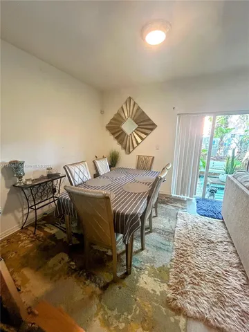 a bedroom with furniture and a large window