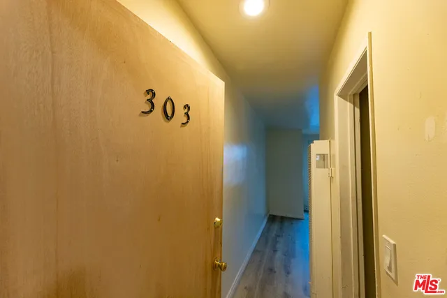 a view of a hallway with wooden floor
