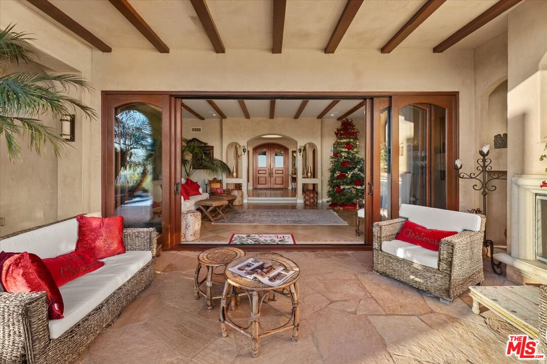 1740 Carla Ridge Beverly Hills, CA 90210 - Photo 13 of 36 a living room with furniture and a potted plant