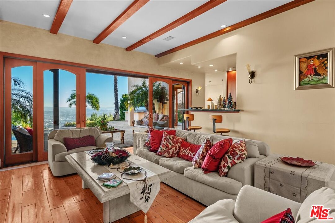 1740 Carla Ridge Beverly Hills, CA 90210 - Photo 20 of 36 a living room with furniture and a large window