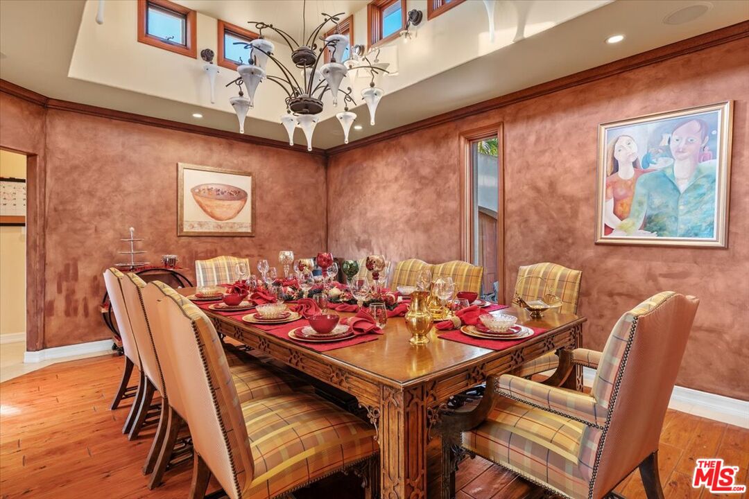 1740 Carla Ridge Beverly Hills, CA 90210 - Photo 21 of 36 a view of a dining room with furniture a chandelier and wooden floor