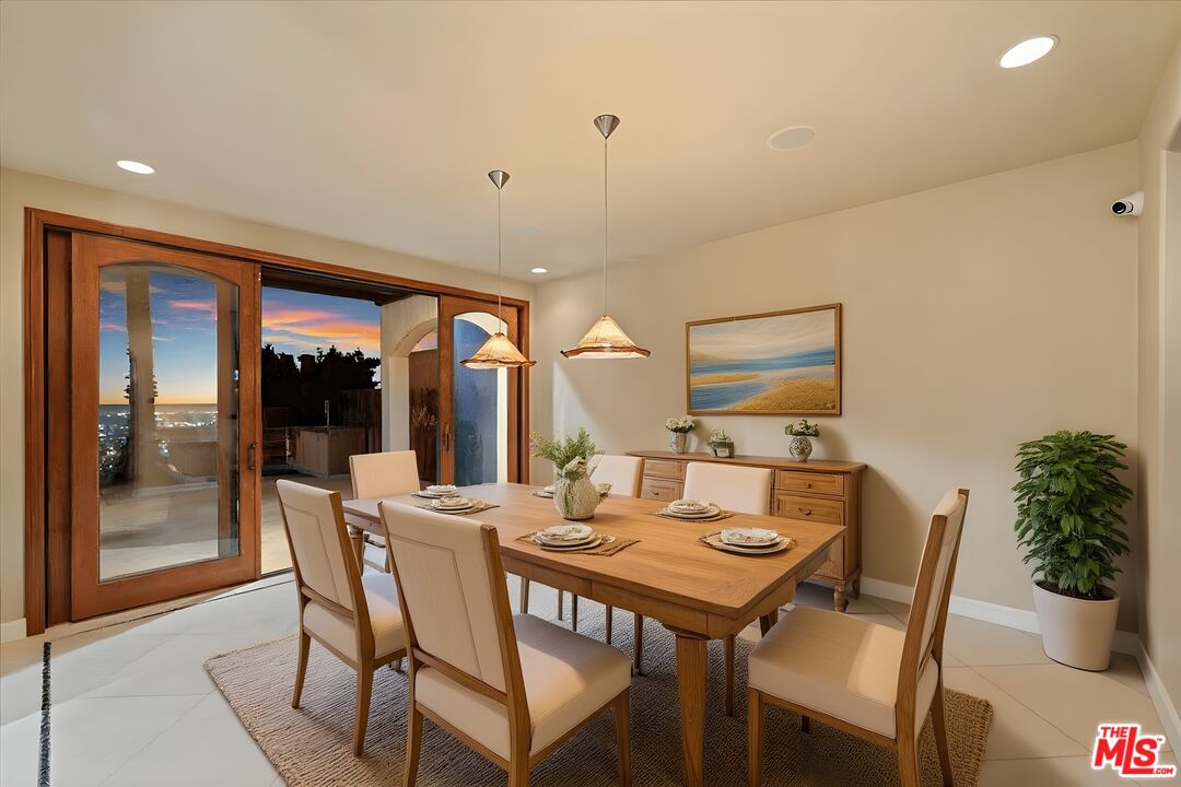 1740 Carla Ridge Beverly Hills, CA 90210 - Photo 24 of 36 a dining room with furniture window and outdoor view