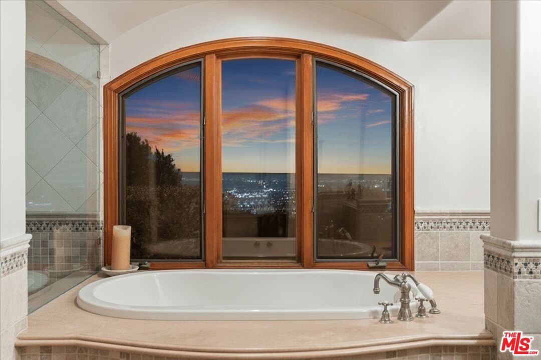 1740 Carla Ridge Beverly Hills, CA 90210 - Photo 28 of 36 a bathroom with a bathtub and a shower