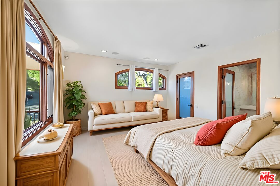 1740 Carla Ridge Beverly Hills, CA 90210 - Photo 29 of 36 a bedroom with a bed and a large window with outer view