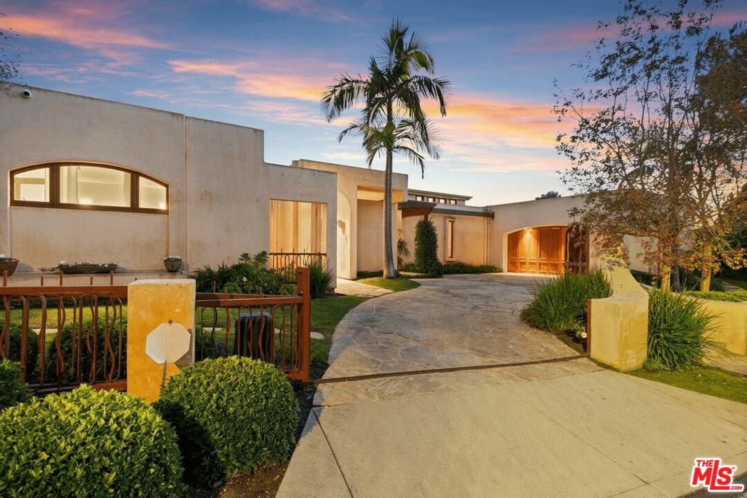 1740 Carla Ridge Beverly Hills, CA 90210 - Photo 4 of 36 a front view of a house with a garden