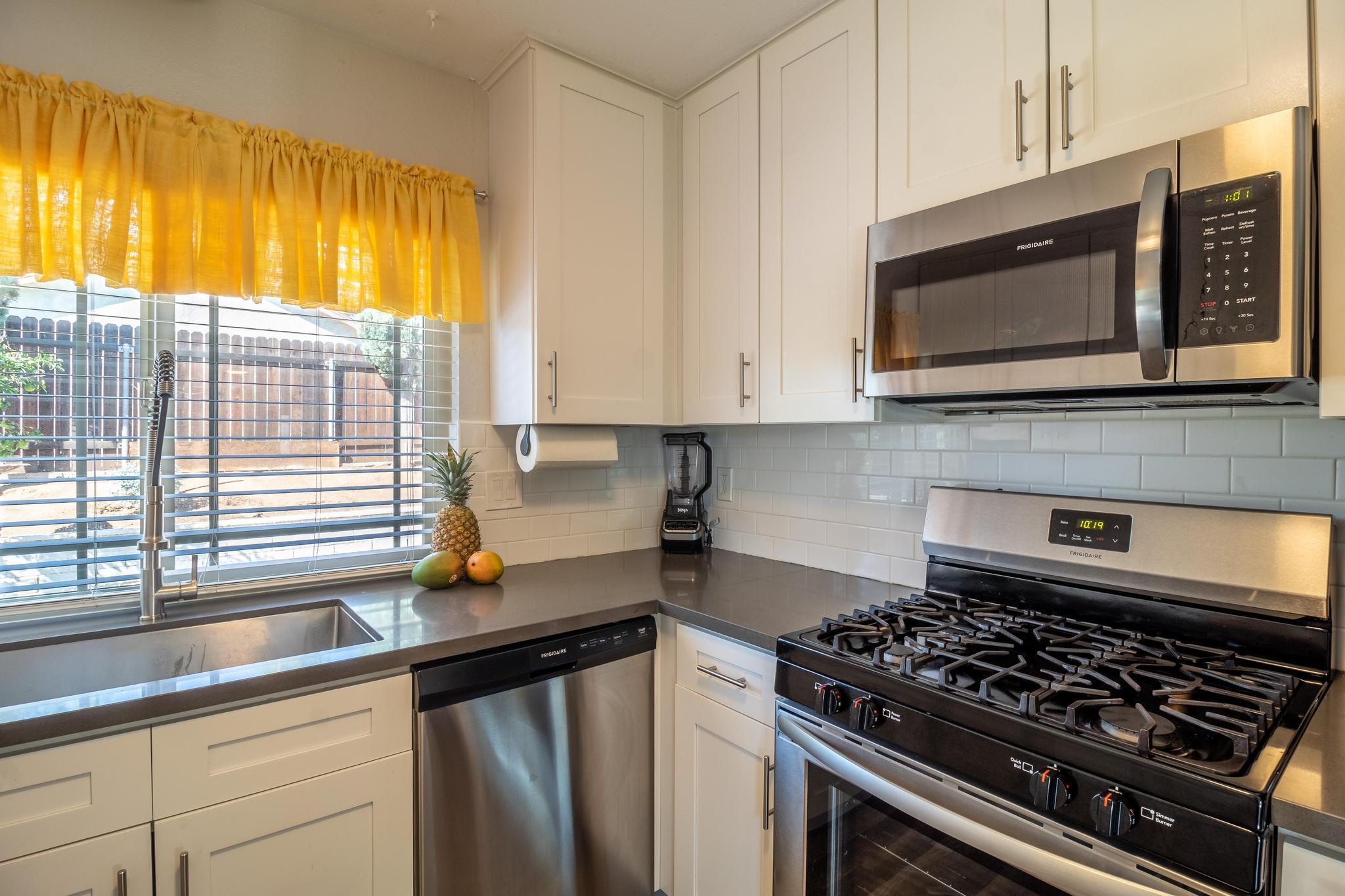 6875 Crest Avenue Riverside, CA 92503 - Photo 11 of 31 a kitchen with stainless steel appliances a stove a microwave sink and cabinets
