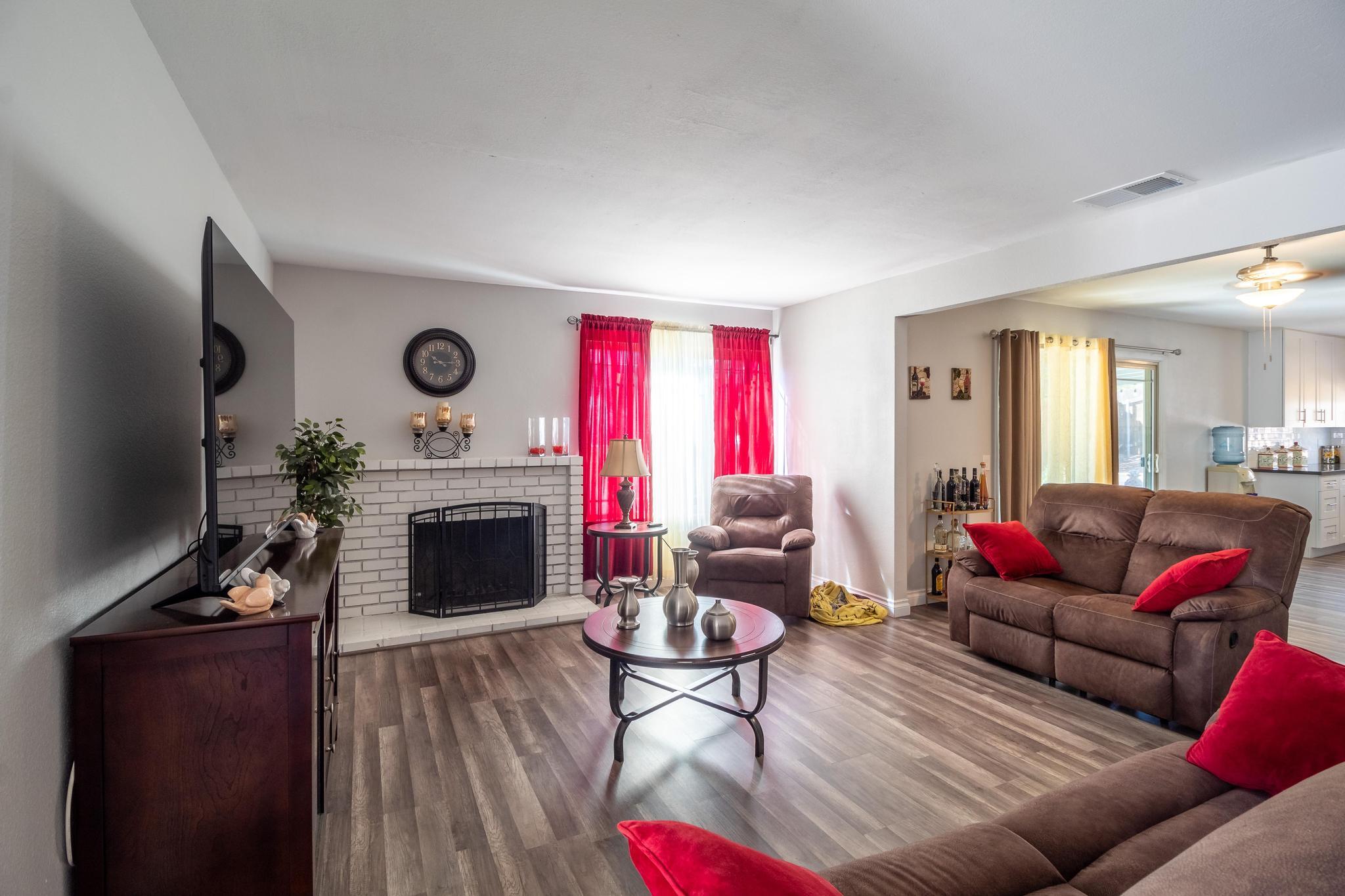 6875 Crest Avenue Riverside, CA 92503 - Photo 3 of 31 a living room with furniture flat screen tv and a fireplace