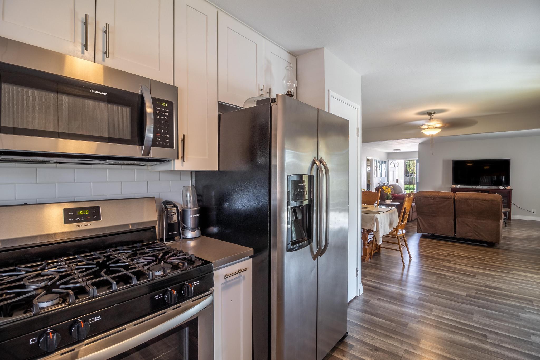 6875 Crest Avenue Riverside, CA 92503 - Photo 10 of 31 a kitchen with stainless steel appliances granite countertop a stove and a refrigerator