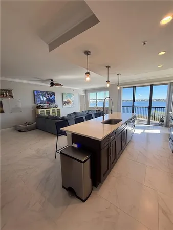 a spacious bedroom with a bed and a flat screen tv