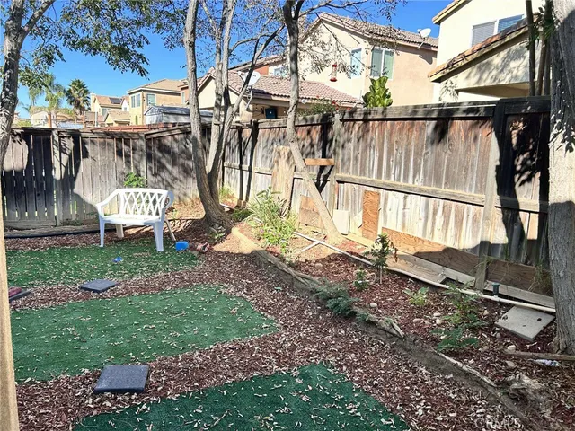 a view of a backyard with a tree