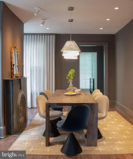 a view of a dining room with furniture and a chandelier