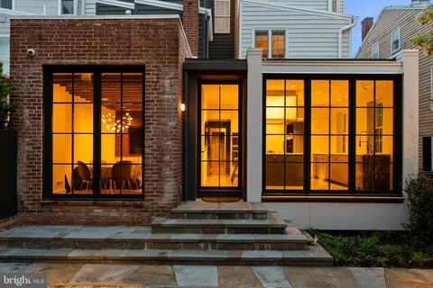a front view of a house with a floor to ceiling windows
