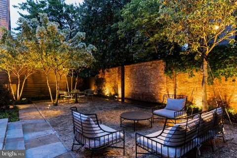 a backyard of a house with table and chairs
