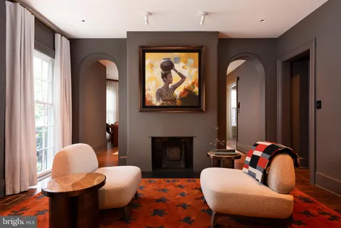 a living room with furniture fireplace and window
