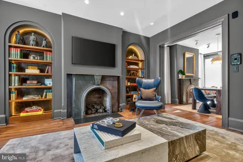 a living room with furniture a rug and a fireplace